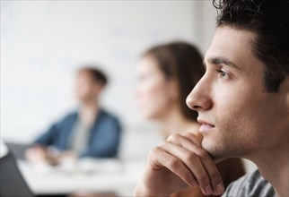 Close up of student listening in college classroom