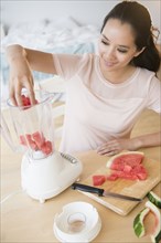 Chinese woman blending watermelon