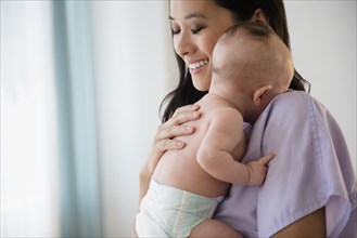 Chinese nurse holding baby