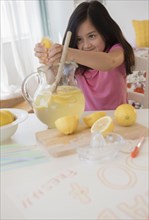 Girl squeezing lemons for lemonade