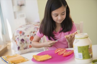 Girl making lunch sandwiches