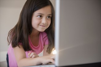 Smiling girl using laptop