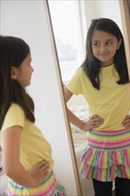 Girl admiring herself in mirror