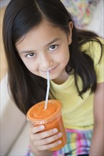 Girl drinking healthy carrot juice