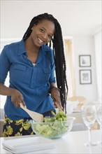Black woman tossing salad
