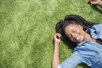 Black woman laying in grass