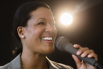 Black businesswoman talking into microphone
