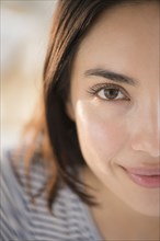 Close up of face of smiling Hispanic woman