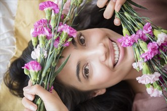 Hispanic woman holding flowers