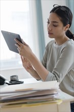 Hispanic businesswoman using digital tablet