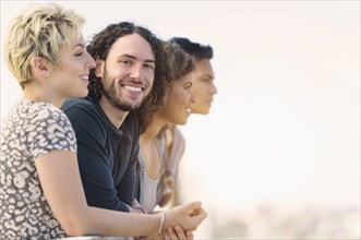 Man smiling with friends outdoors