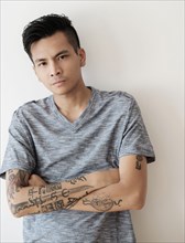 Serious Asian man with arms crossed