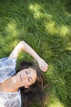 Caucasian woman laying in grass