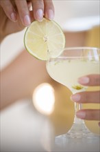 Hispanic woman drinking cocktail