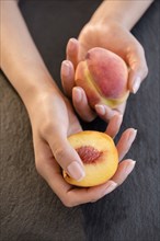 Hispanic woman holding peaches