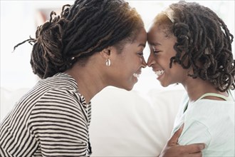 Black mother and daughter touching noses