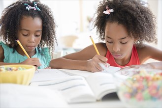 Mixed race sisters doing homework