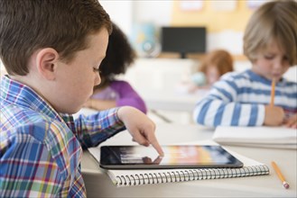 Student using digital tablet in classroom