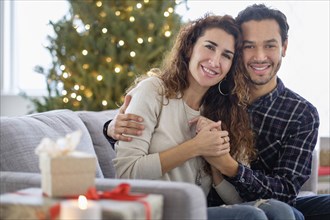 Couple hugging on sofa