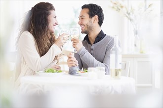 Couple toasting each other with wine