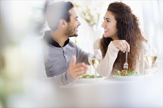 Smiling couple eating at table