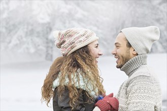 Couple smiling in snow