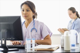 Nurse using computer in hospital