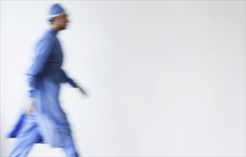 Blurred view of mixed race surgeon walking