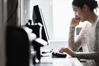 Hispanic woman using computer