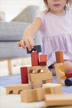 Caucasian girl playing with wooden blocks