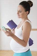 Pregnant Caucasian woman using cell phone