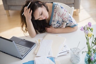 Stressed woman paying bills
