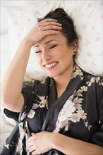 Woman laughing on bed