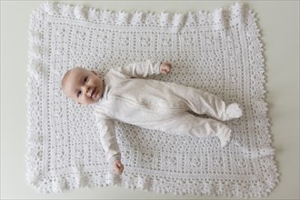 Caucasian baby laying on blanket