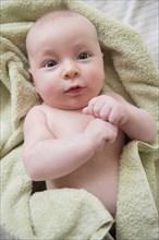 Caucasian baby wrapped in towel