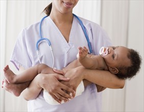 African nurse holding baby