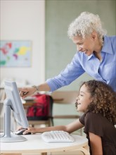 Teacher and student using computer