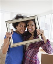 Friends looking through empty frame