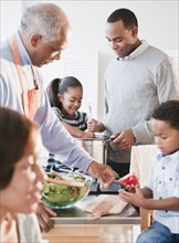 African American family cooking together