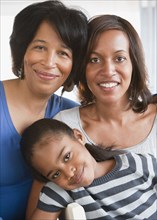 Black grandmother smiling with daughter and granddaughter