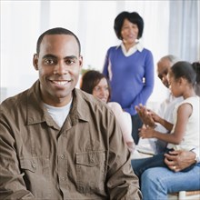 African American man in living room with family