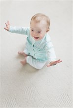 Caucasian baby girl with Down Syndrome laughing