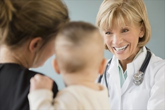 Caucasian mother and daughter talking with doctor