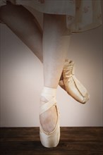 Legs of Caucasian ballerina standing en pointe