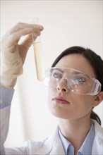 Caucasian scientist holding vial