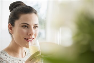Caucasian woman drinking champagne