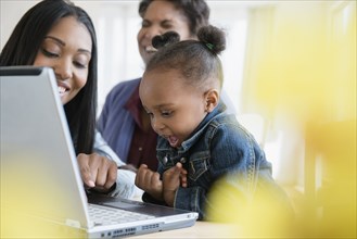 Black multi-generation family using laptop