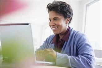 Older black woman using laptop