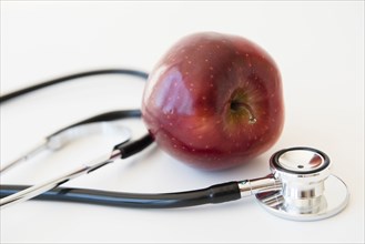 Stethoscope and red apple