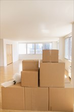 Cardboard boxes and bubble wrap in empty apartment